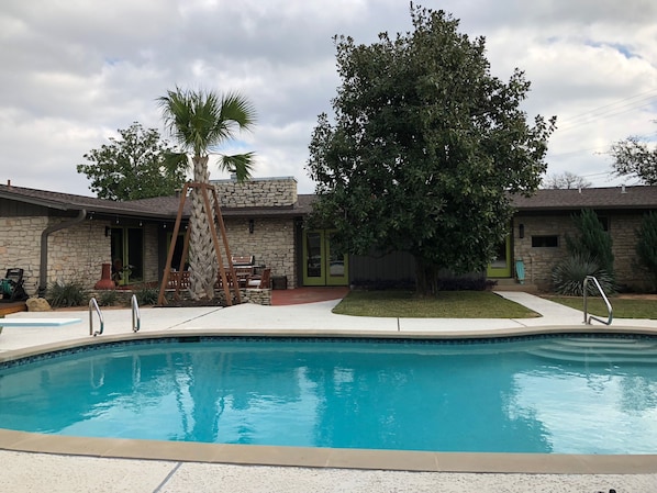 Our kidney-shaped pool has a midcentury retro vibe and a diving board too!