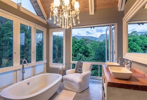 Gorgeous master bath w/doors opening onto spectacular mountain views