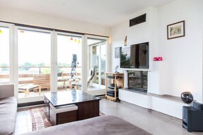 Living room, with flat TV screen and fireplace