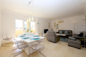 Full view of the lounge and dining area with access to the terrace