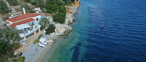 Tyhe beach with sunbeds and umbrella , Kayak along the coves to explore 