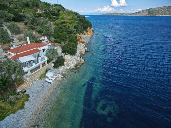 Tyhe beach with sunbeds and umbrella , Kayak along the coves to explore 