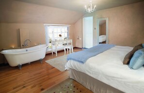 Ground floor: Double bedroom with 6'6 bed and freestanding roll top bath