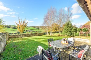 The garden area with table seating four guests enjoys uninterrupted views of the surrounding countryside