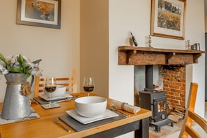 Ground floor: Dining table seating two with wood burning stove