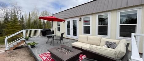 deck facing lake, with patio sectional and propane fire table
