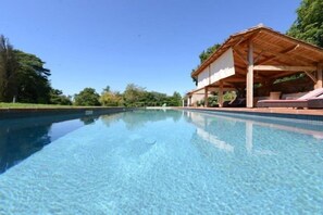 Pool and shaded lounging area.