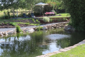 Private garden seating area overlooking the pond