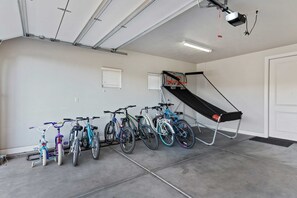 Two-car garage with bikes for everyone and basketball game