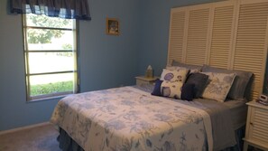 Master bedroom; has adjoining bathroom that leads out to pool deck.