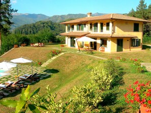 The large villa sits alone with views ove the town and valley