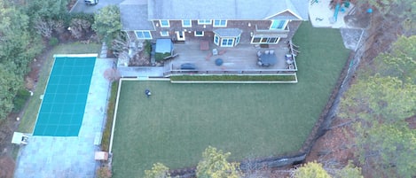 Large backyard, deck with hot tub, and heated pool with blue stone patio.
