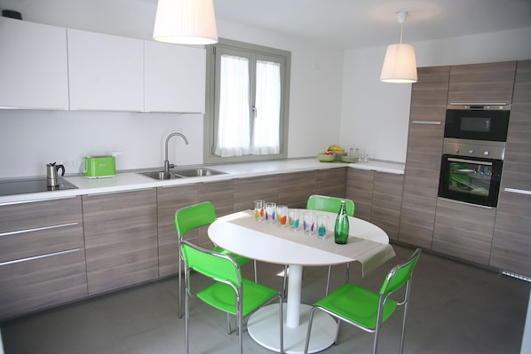 Kitchen complete with appliances and dining table.