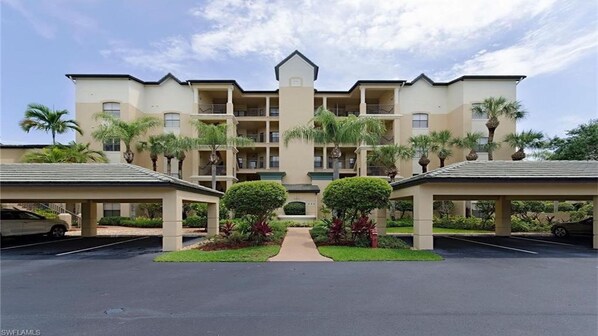 Building entrance.  Golf course behind.  
