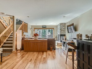 Wet bar, and view toward deck and fireplace