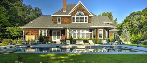 Heated, salt water gunite pool with hot tub and diving rock.