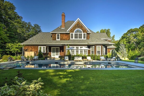 Heated, salt water gunite pool with hot tub and diving rock.