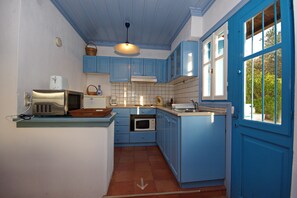 The cute Greek style kitchen , well  equipped for home cooking ,full oven ,hob