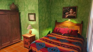 Queen bedroom w/ ensuite bathroom, A/C, ceiling fan and Mexican artsy decor. 