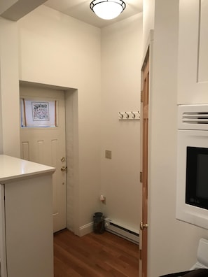 Entry foyer with ample space. Coat/bag rack, area for shoes, shelf for keys.