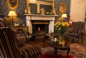 White marble fireplace with open fire