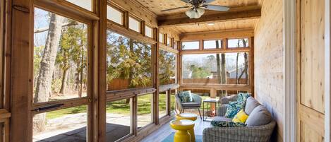 Enjoy breezy evenings on this stunning screened in porch with ceiling fan. 