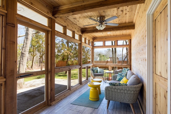 Enjoy breezy evenings on this stunning screened in porch with ceiling fan. 