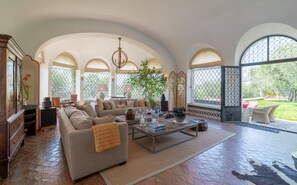 Living room opens up to the garden and pool beyond