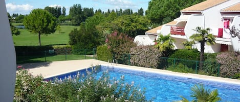 view from the terrace on the golf court and the swimming pool