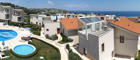 Wide angle view from the top terrace of villa 15 over the sea, pools, Byala