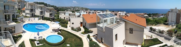 Wide angle view from the top terrace of villa 15 over the sea, pools, Byala