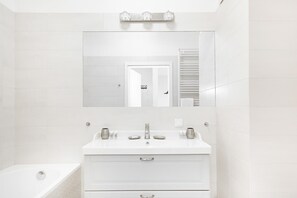Bright bathroom with towels and shower cabin. 