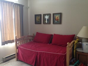 Bedroom with bed plus trundle underneath.