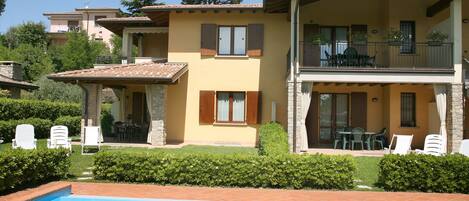 Exterior facade of the residence overlooking the pool, solarium and gardens.