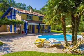 La villa et la piscine au milieu de la pinède