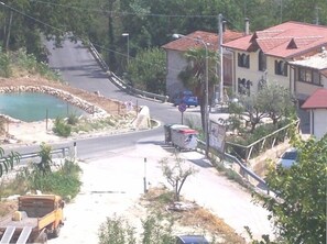 West view showing pond and main road and house