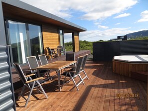 The front terrace with garden furniture and hot tub.