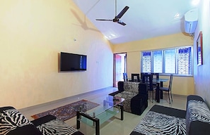 Living /Dining room, 50" flatscreen TV and walkout to Balcony