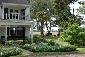 Upstairs and Downstairs covered side porches with table and seating