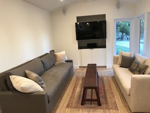 Sitting room connected to kitchen with garden views