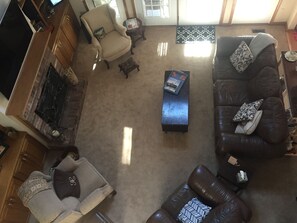 View into living room from open balcony above.