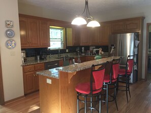 Raised bar to enjoy breakfast or sit and talk with the cook.