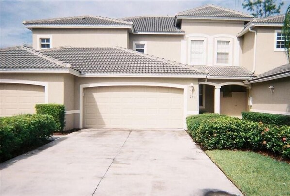 Front of condo has a two car attached garage