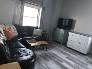 The white kitchen island is on wheels, making it easy to move around as needed.