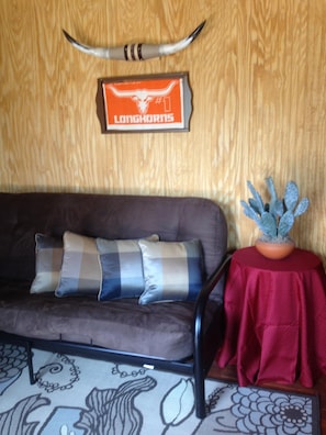 Comfortable queen futon located in living area of Longhorn Cabin, can sleep four