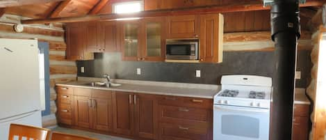 Modern kitchen with a full compliment of dishes, utensils and pots and pans.