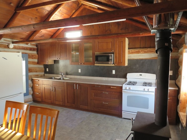 Modern kitchen with a full compliment of dishes, utensils and pots and pans.