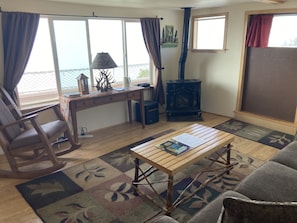 Living room with large window overlooking the bay and gas fireplace