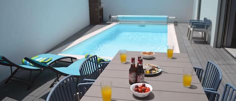 Terrace with private heated pool, barbecue and dining area