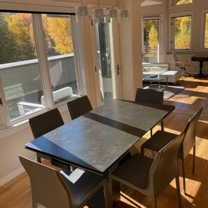 Newly furnished dining room looking into living room with breathtaking views!